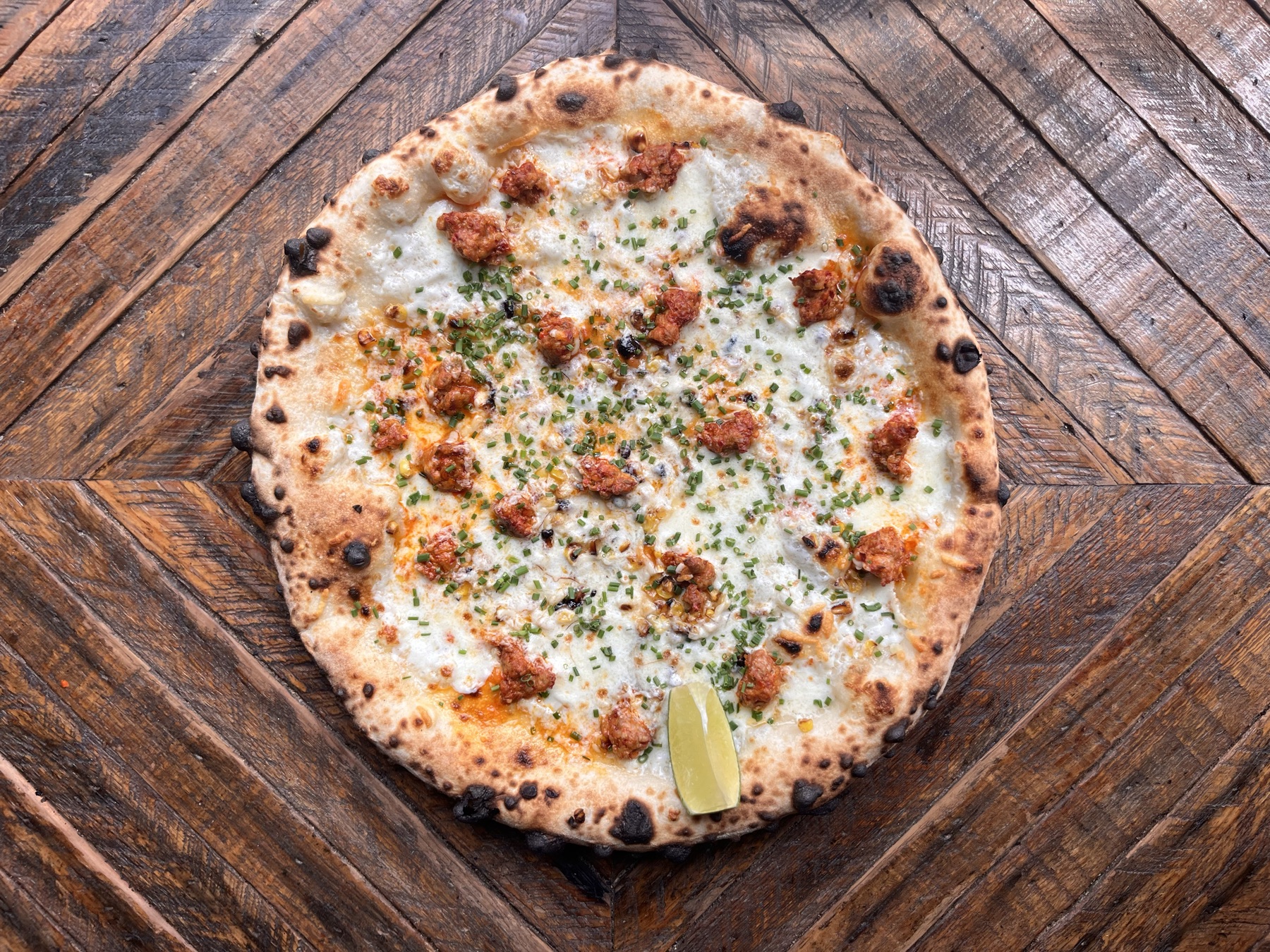 Wood-fired pizza with crumbled meat